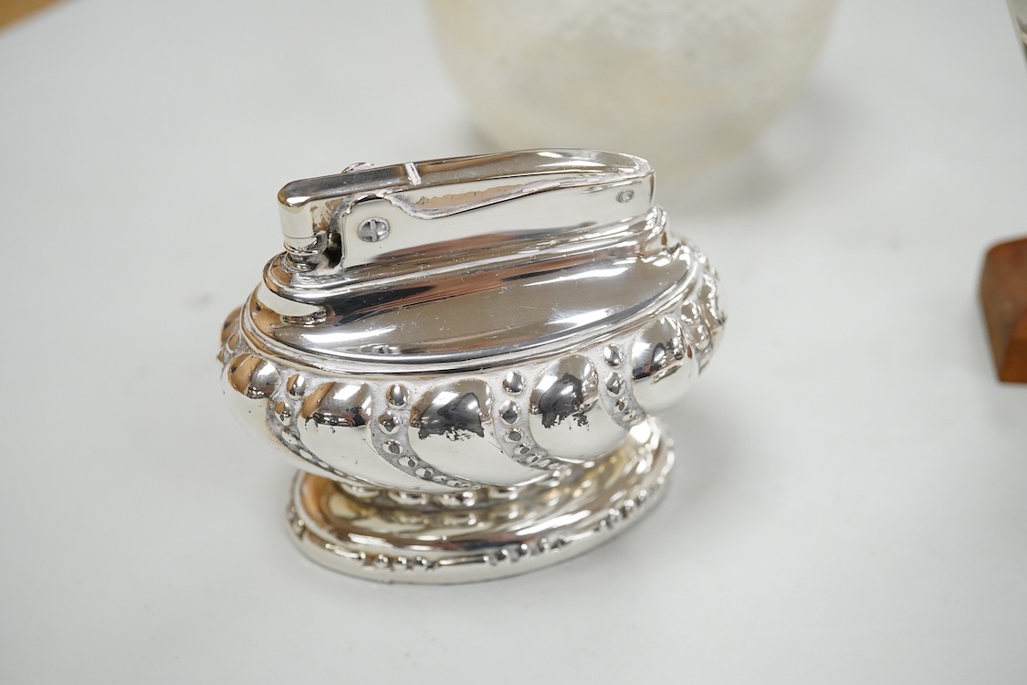 A collection of silver or white metal to include a miniature model dhal, ashtray, scent bottle and toilet jar, together with a metal Ronson table lighter.